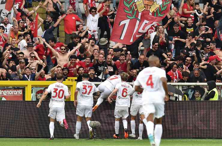 Monza players cheer after a goal